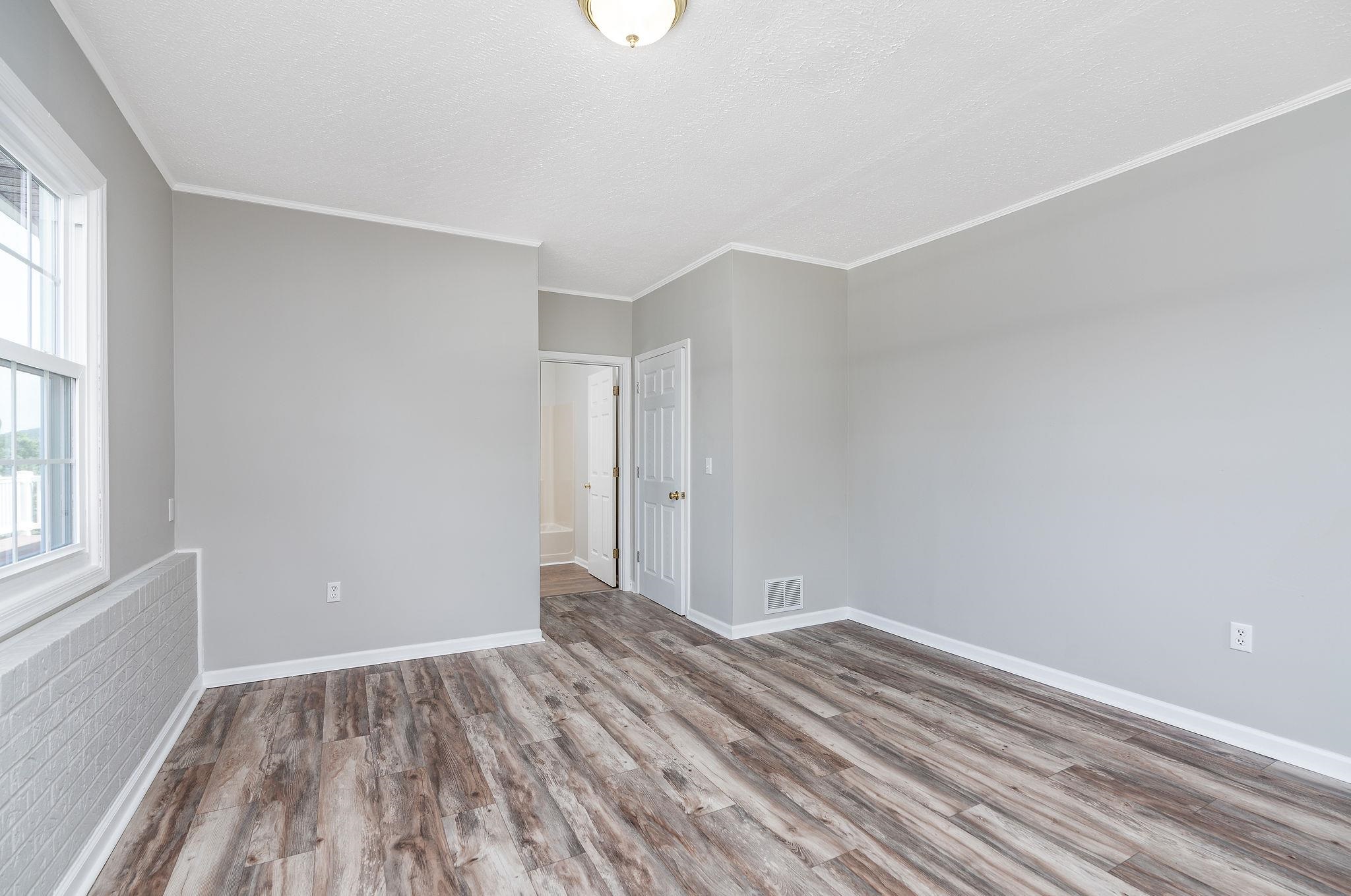 308 Stonewall Road Weyers Cave, VA 24486 - Photo 67 of 71 a view of room with window and wooden floor