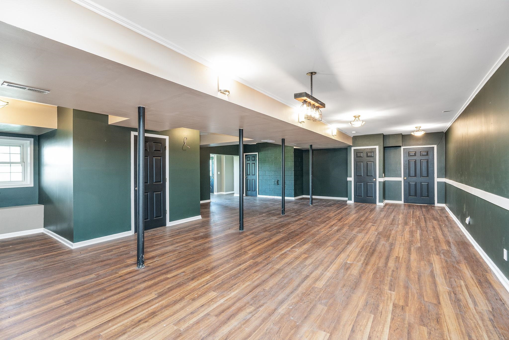 308 Stonewall Road Weyers Cave, VA 24486 - Photo 69 of 71 a view of a room with wooden floor ceiling fan and window