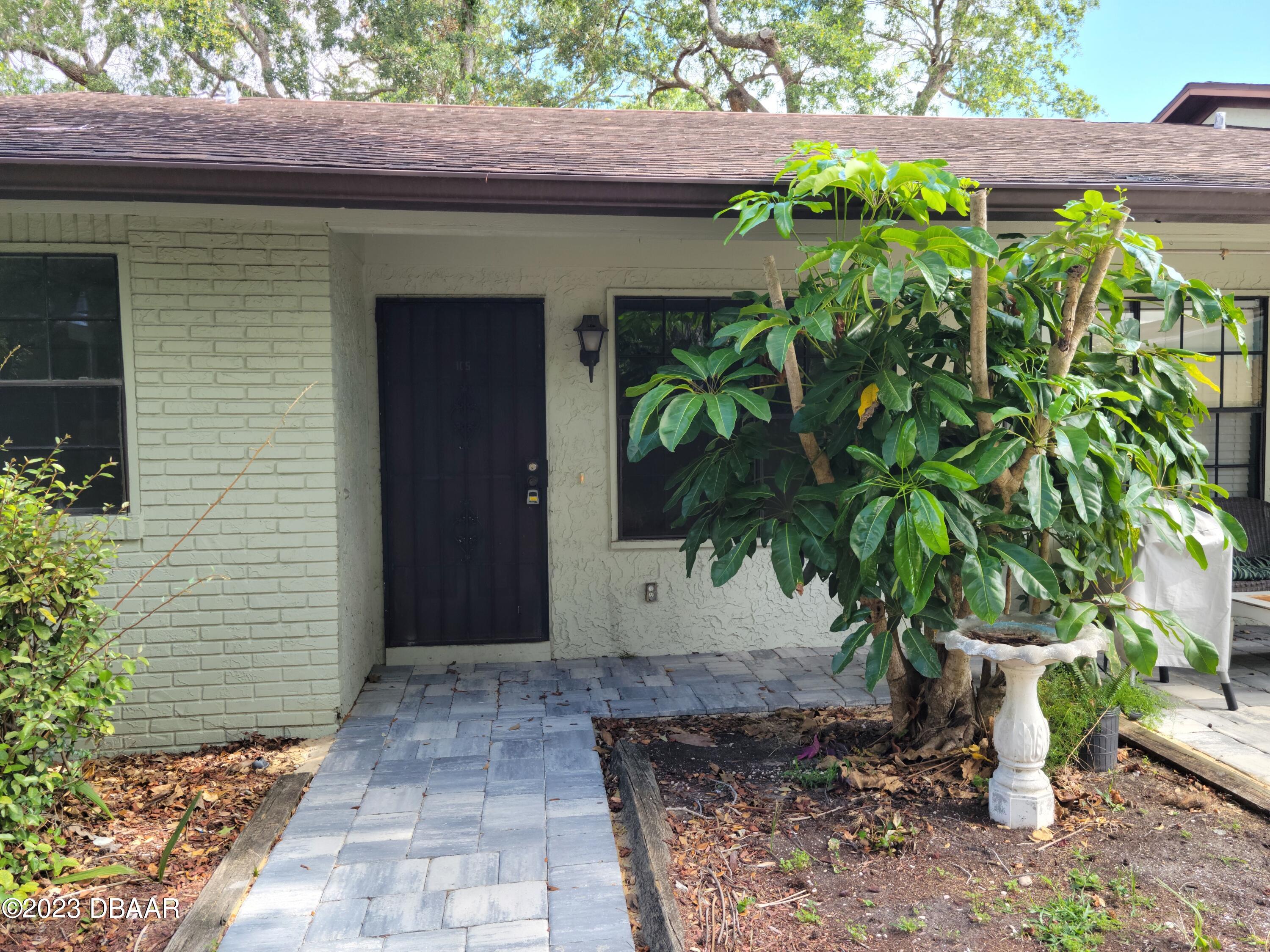 526 Live Oak Street, Unit 1050 Edgewater, FL 32132 - Photo 1 of 26 a view of a potted plants in front of a brick house