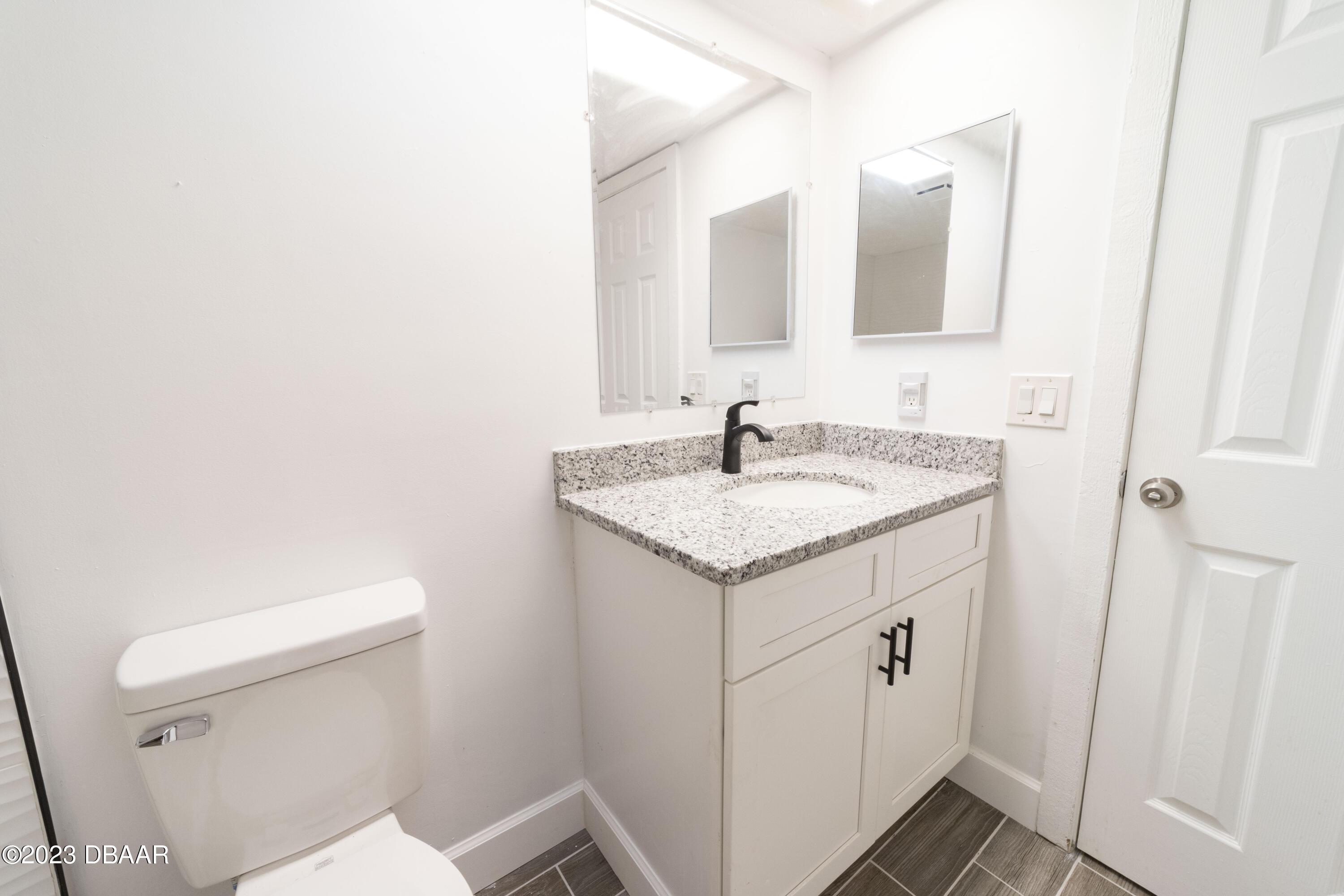 526 Live Oak Street, Unit 1050 Edgewater, FL 32132 - Photo 11 of 26 a bathroom with a sink a toilet and a mirror