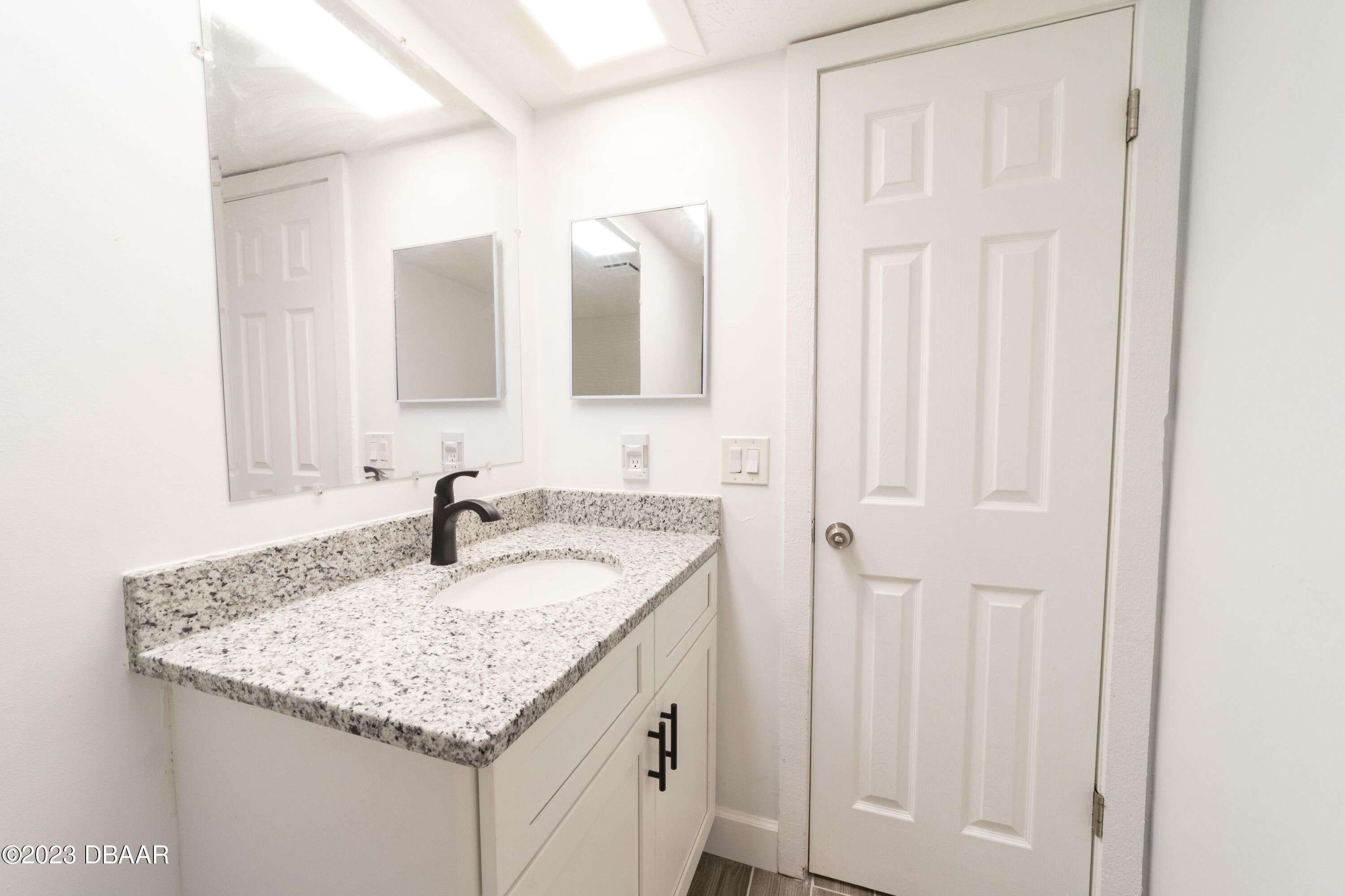 526 Live Oak Street, Unit 1050 Edgewater, FL 32132 - Photo 13 of 26 a bathroom with a granite countertop sink and a mirror