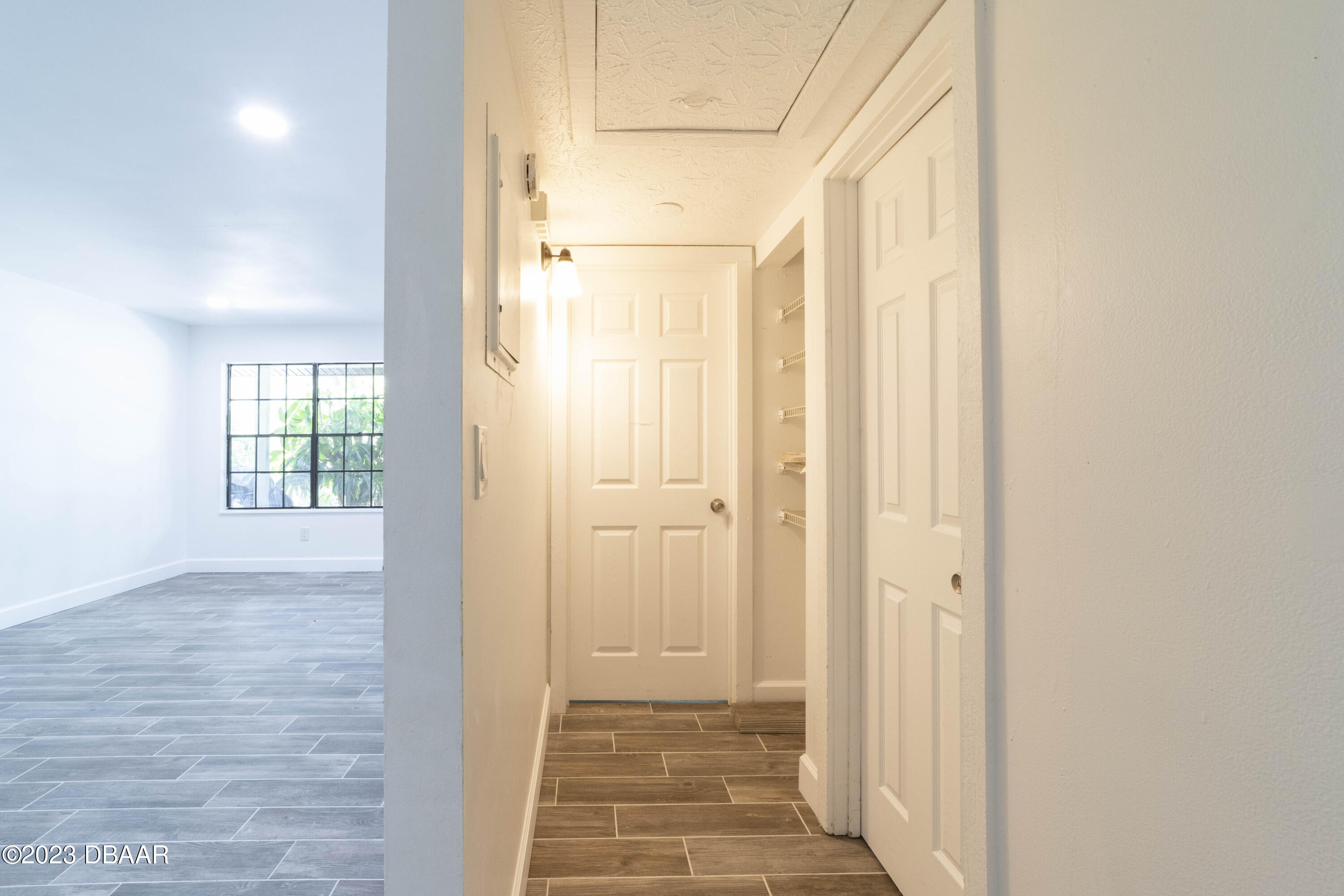 526 Live Oak Street, Unit 1050 Edgewater, FL 32132 - Photo 19 of 26 a view of a hallway with wooden floor and a bathroom