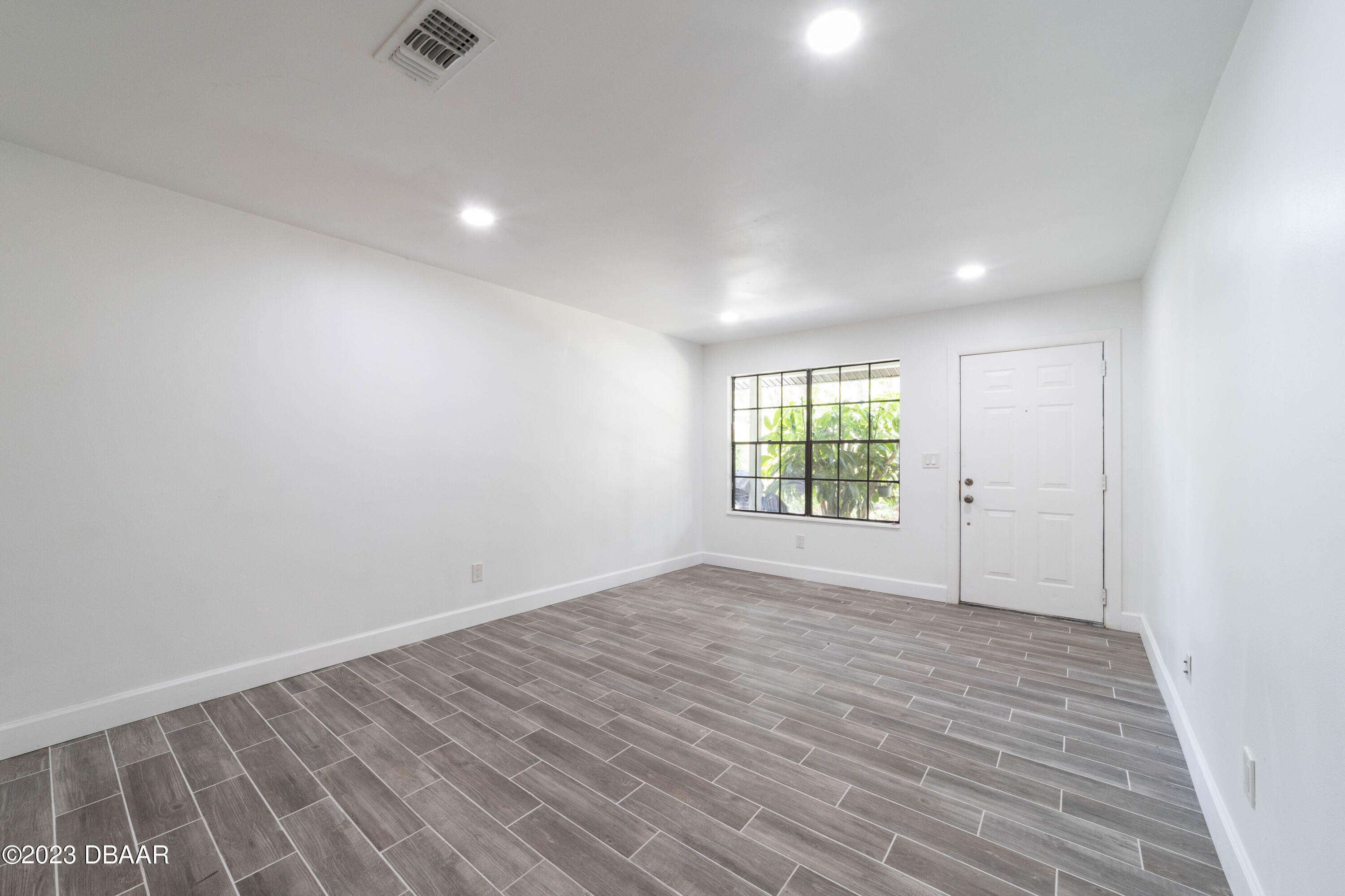 526 Live Oak Street, Unit 1050 Edgewater, FL 32132 - Photo 20 of 26 wooden floor in an empty room with a window