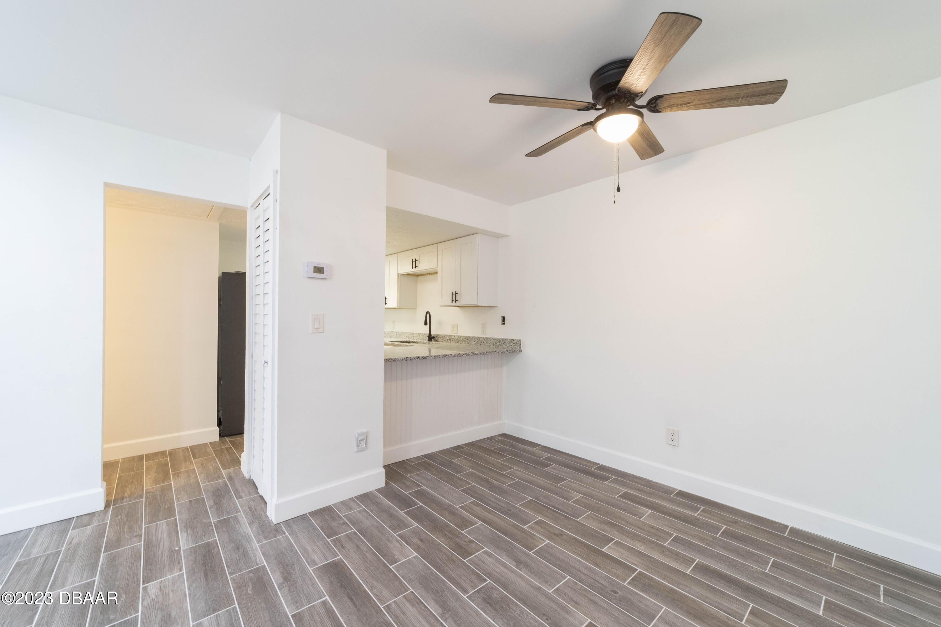 526 Live Oak Street, Unit 1050 Edgewater, FL 32132 - Photo 5 of 26 a view of a kitchen with a sink and dishwasher with wooden floor
