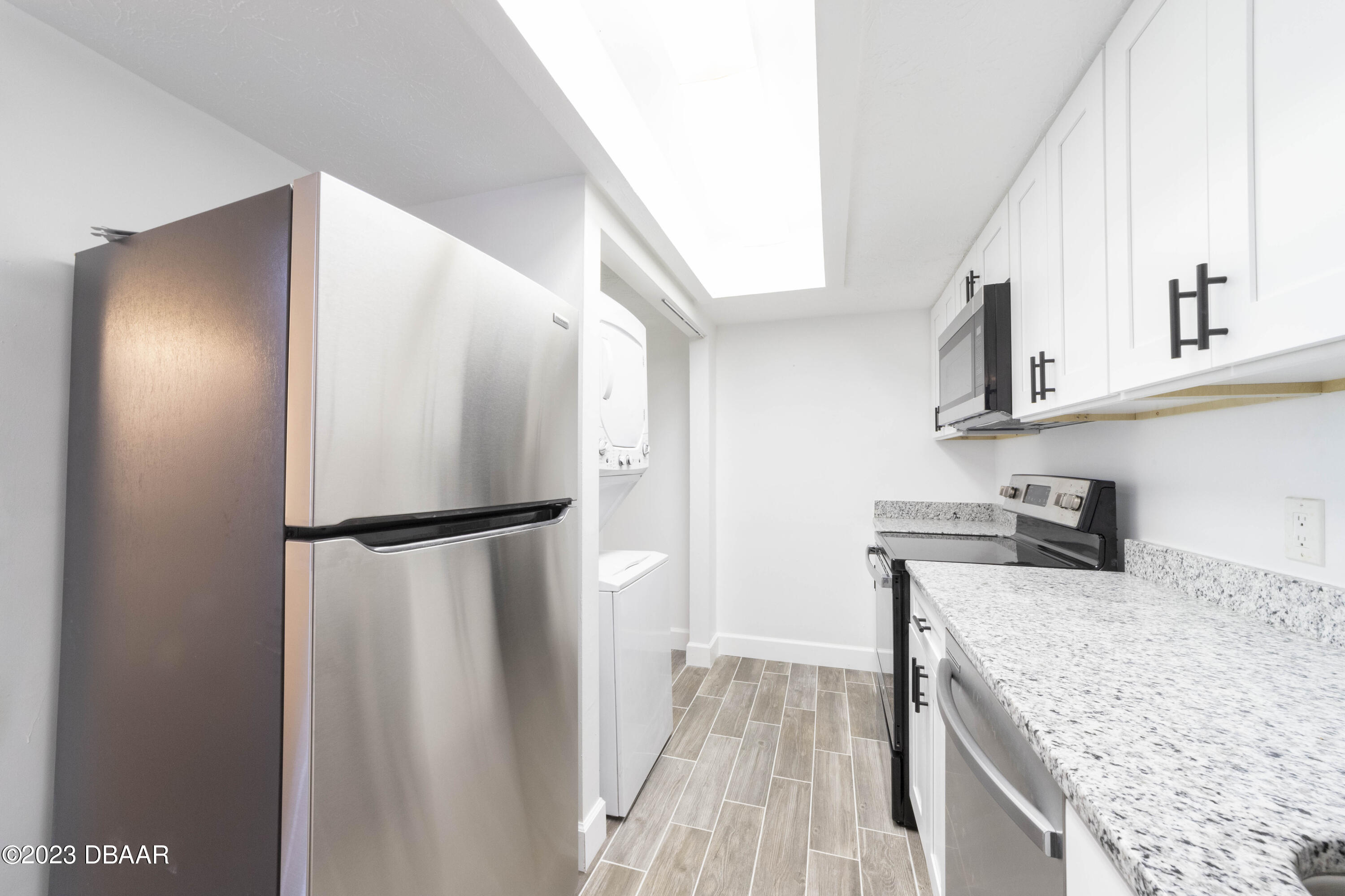 526 Live Oak Street, Unit 1050 Edgewater, FL 32132 - Photo 8 of 26 a kitchen with a refrigerator and a sink