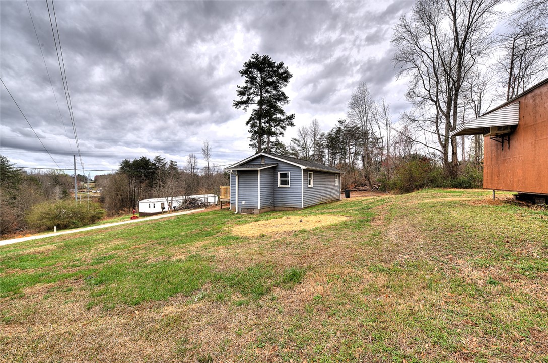 325 Rock Quarry Road Travelers Rest, SC 29690 - Photo 34 of 37 This expansive yard features a charming small home, perfect for serene country living.