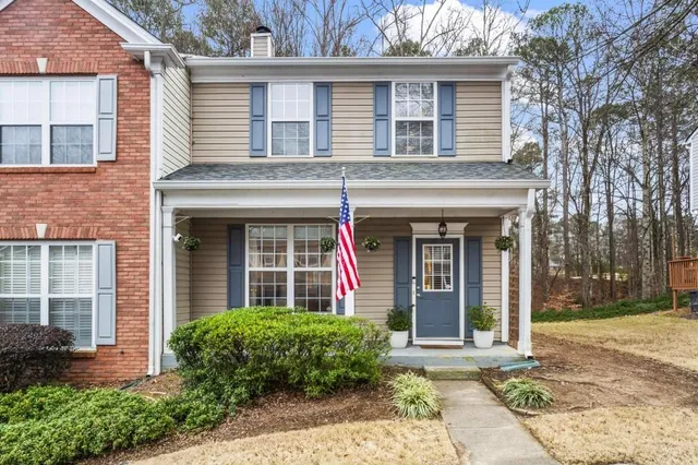 front view of a brick house with a yard