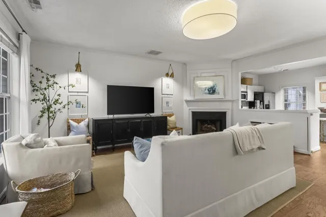 a living room with furniture a flat screen tv and a fireplace