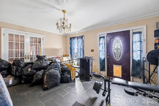 a very nice looking living room with furniture a chandelier and a fireplace