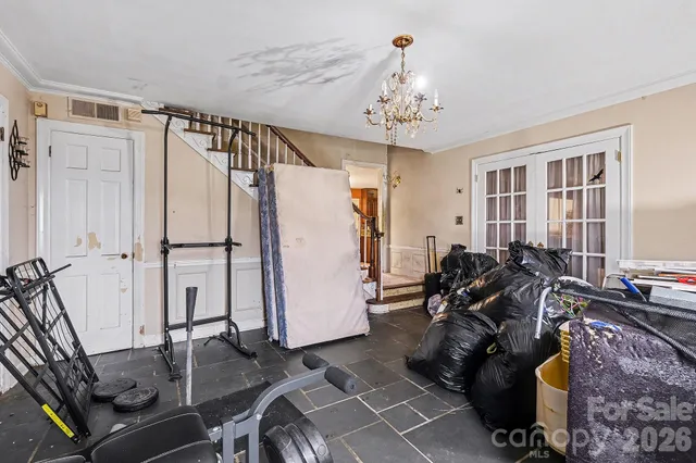 a room with furniture a rug and a chandelier