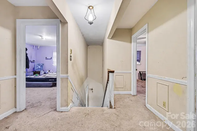 a view of a livingroom with wooden floor and furniture