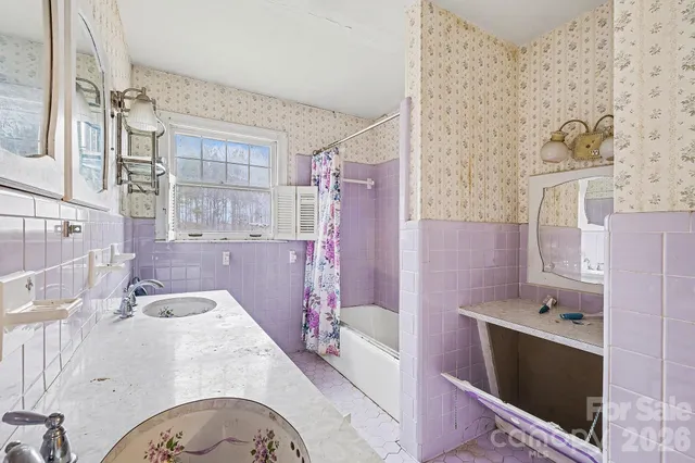 a bathroom with a tub sink and mirror