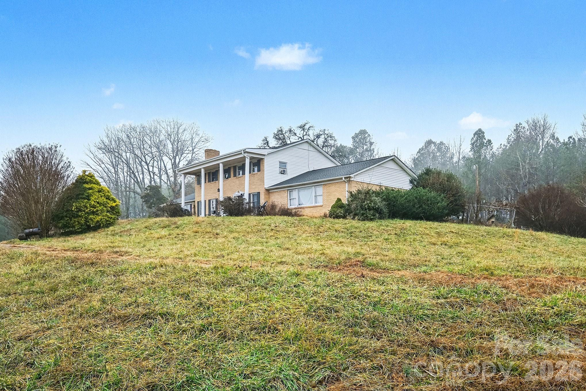 118 Hord Road Lawndale, NC 28090 - Photo 3 of 41 a front view of a house with a yard and mountain view in back