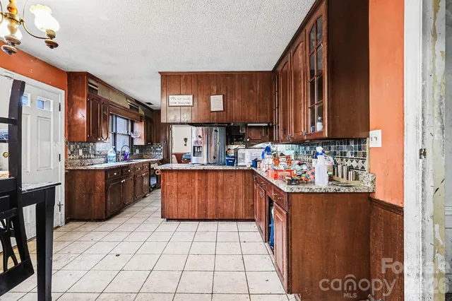 a kitchen with stainless steel appliances granite countertop a stove a sink dishwasher and cabinets