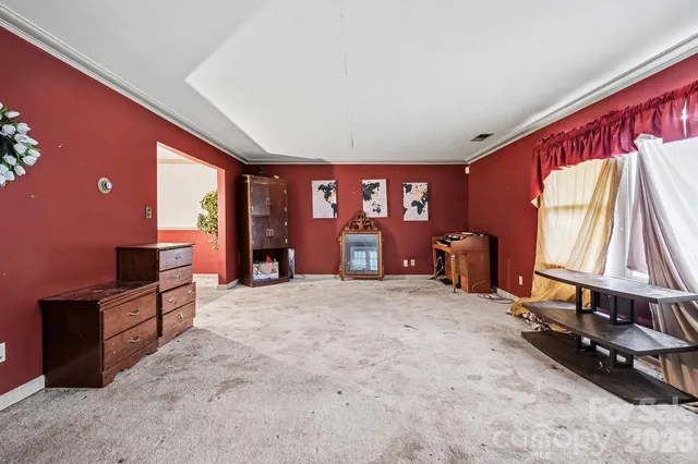 a large bed room with a bed and a chandelier