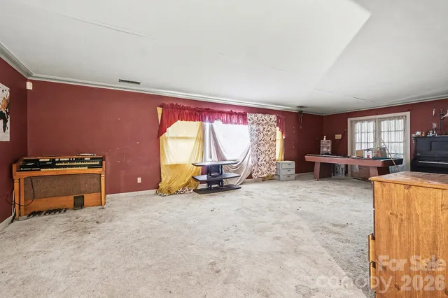 a view of a room with gym equipment and a window