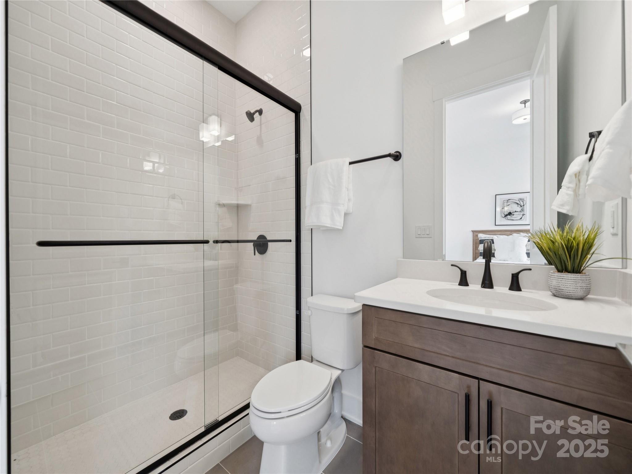 5311 Vernon Rdg Road, Unit 118 Huntersville, NC 28078 - Photo 11 of 22 a bathroom with a sink a toilet and shower