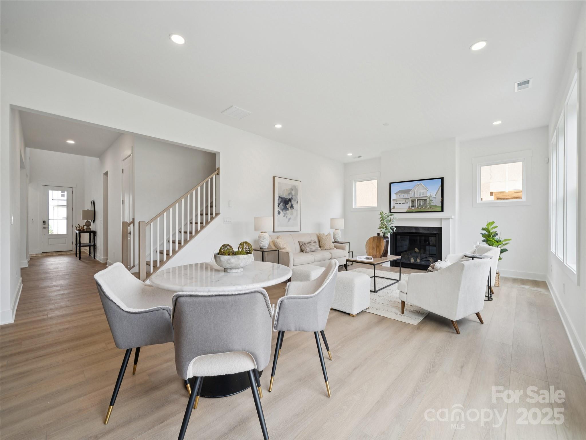 5311 Vernon Rdg Road, Unit 118 Huntersville, NC 28078 - Photo 4 of 22 a living room with furniture a fireplace and a table