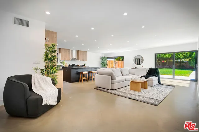 a dining room with furniture and a large window