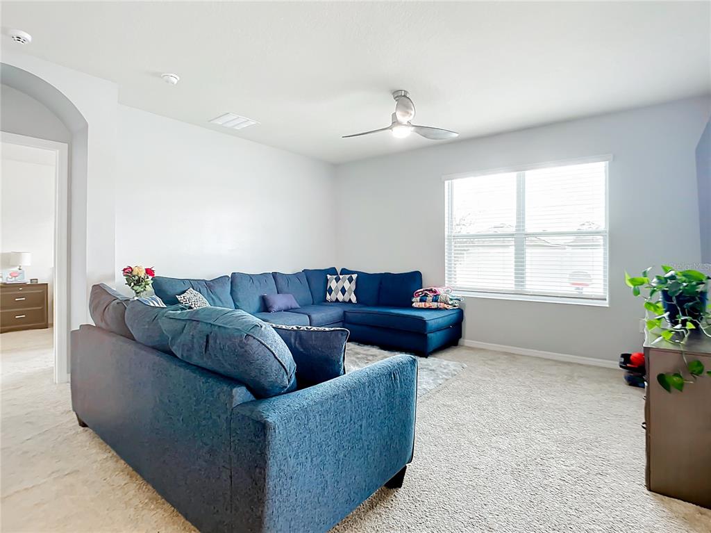 2607 Elmbrooke Way Edgewater, FL 32141 - Photo 11 of 52 a living room with furniture and a window