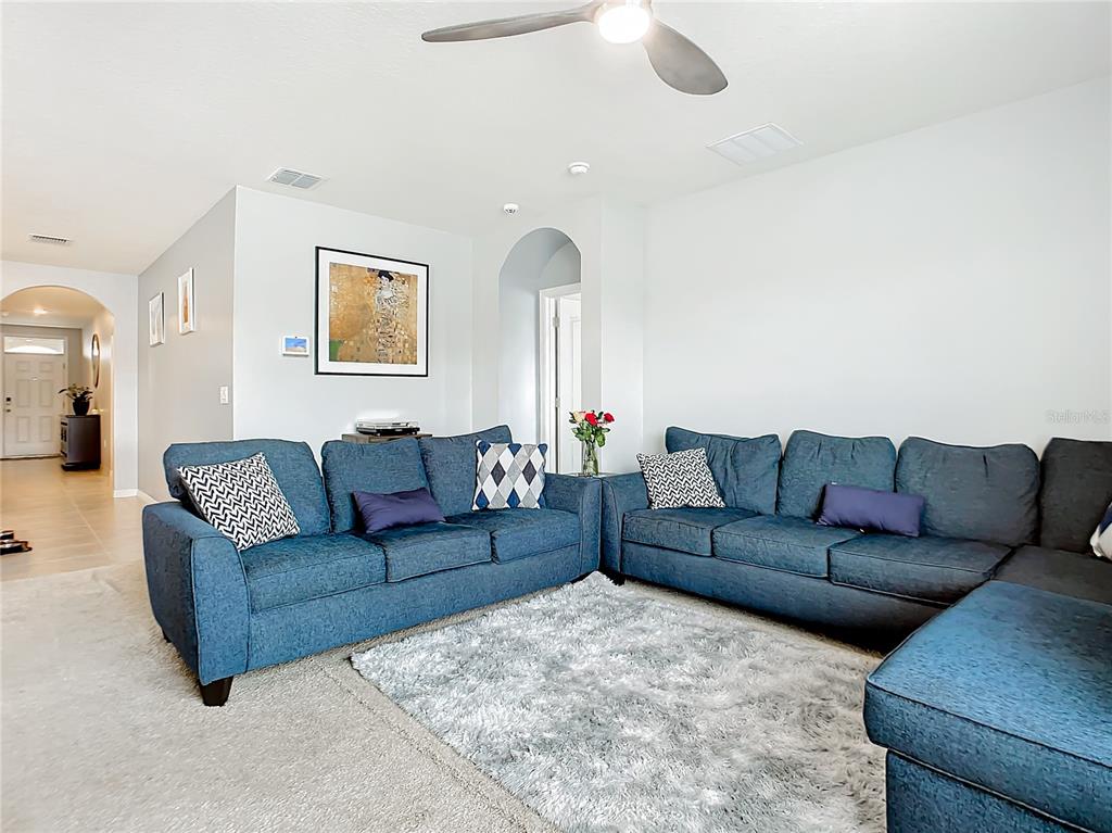 2607 Elmbrooke Way Edgewater, FL 32141 - Photo 12 of 52 a living room with furniture and a large window