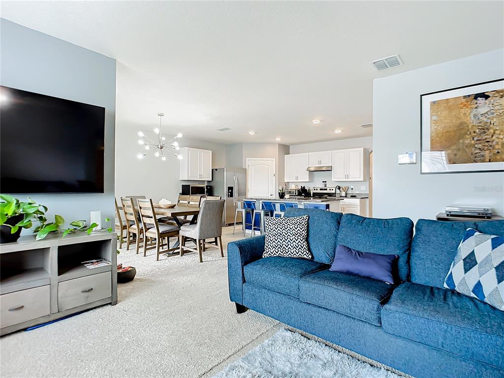2607 Elmbrooke Way Edgewater, FL 32141 - Photo 13 of 52 a living room with furniture and a flat screen tv