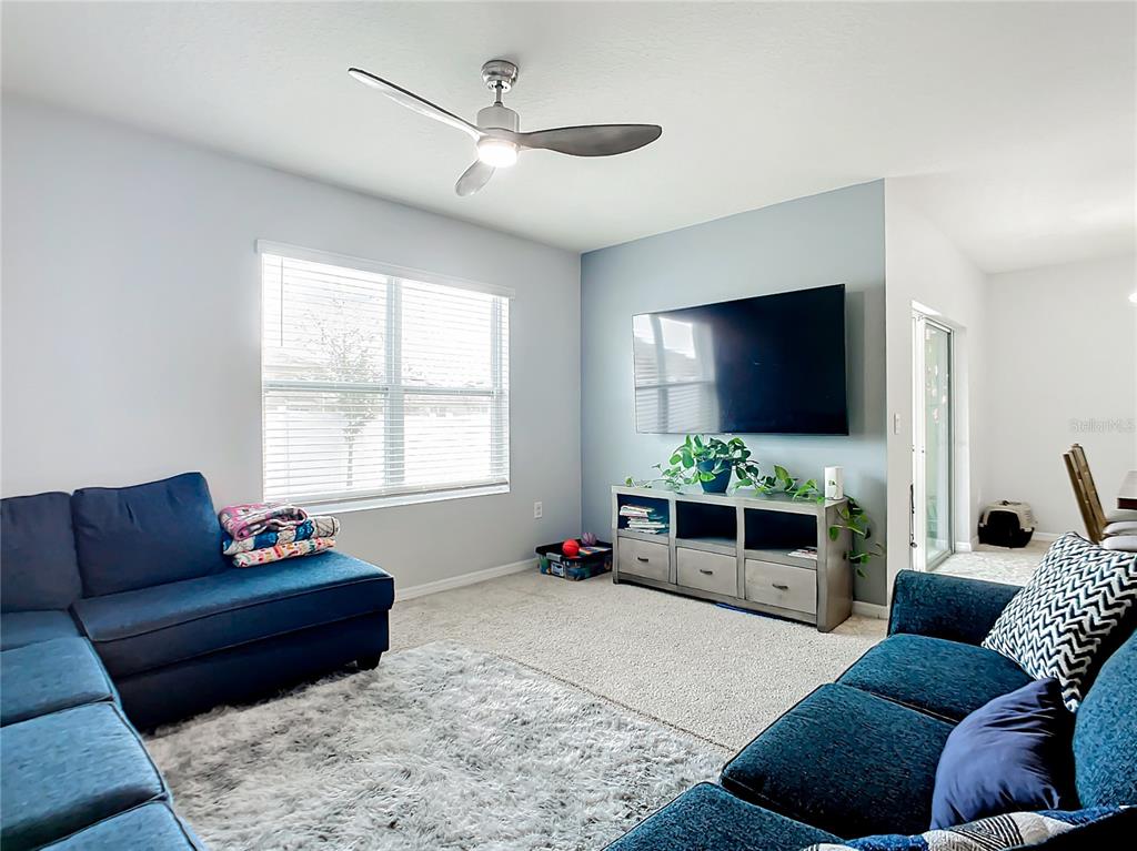 2607 Elmbrooke Way Edgewater, FL 32141 - Photo 14 of 52 a living room with furniture and a flat screen tv