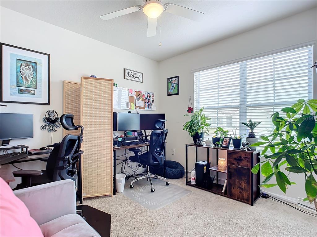 2607 Elmbrooke Way Edgewater, FL 32141 - Photo 28 of 52 a view of a workspace with furniture and a livingroom