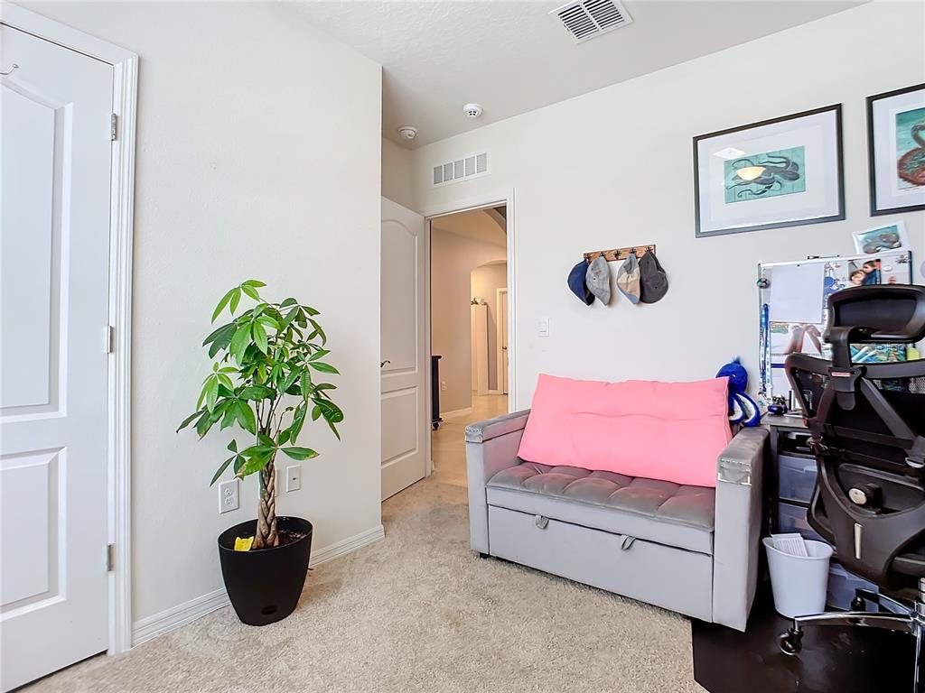 2607 Elmbrooke Way Edgewater, FL 32141 - Photo 30 of 52 a bedroom with a bed and a potted plant