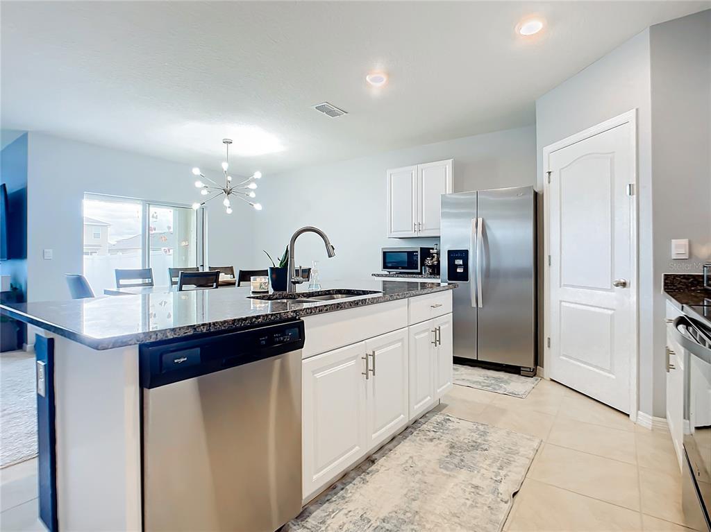 2607 Elmbrooke Way Edgewater, FL 32141 - Photo 3 of 52 a kitchen with stainless steel appliances a sink and a refrigerator