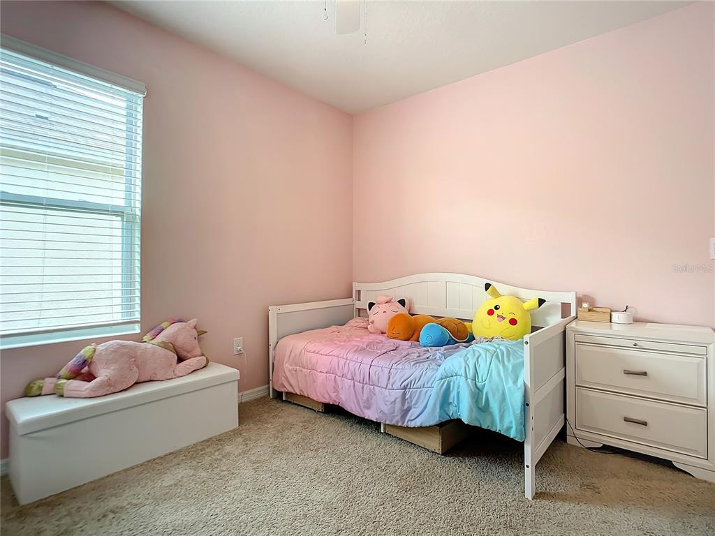 2607 Elmbrooke Way Edgewater, FL 32141 - Photo 32 of 52 a bedroom with a bed and a dresser