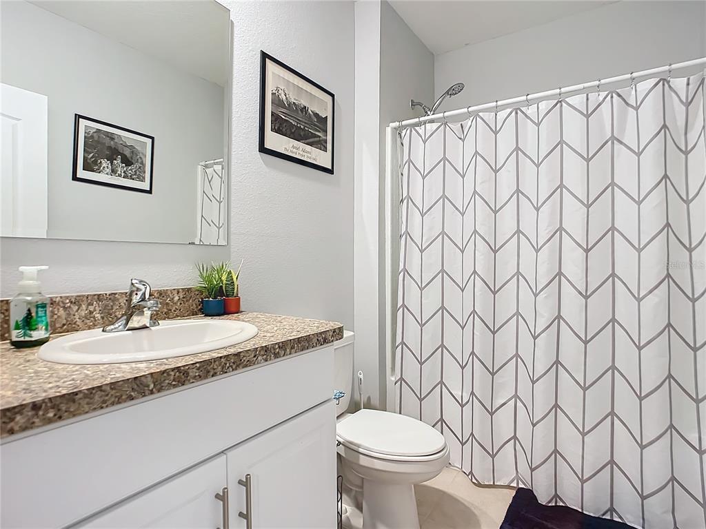 2607 Elmbrooke Way Edgewater, FL 32141 - Photo 35 of 52 a bathroom with a granite countertop sink and a mirror