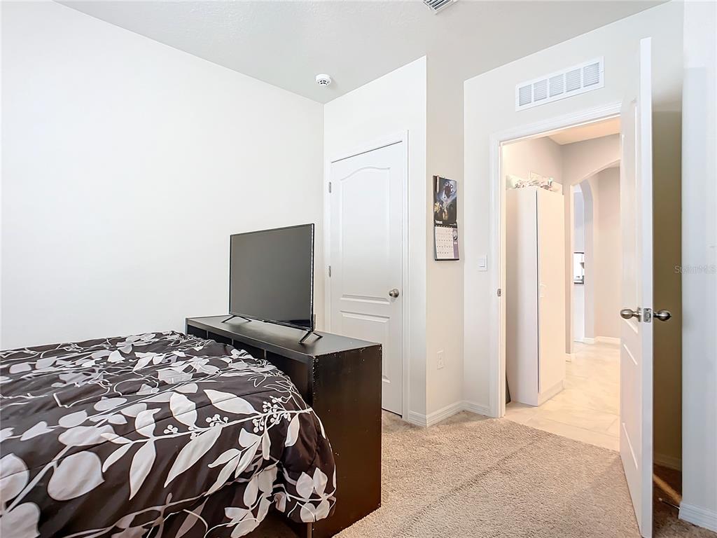 2607 Elmbrooke Way Edgewater, FL 32141 - Photo 36 of 52 a bedroom with a bed and a tv