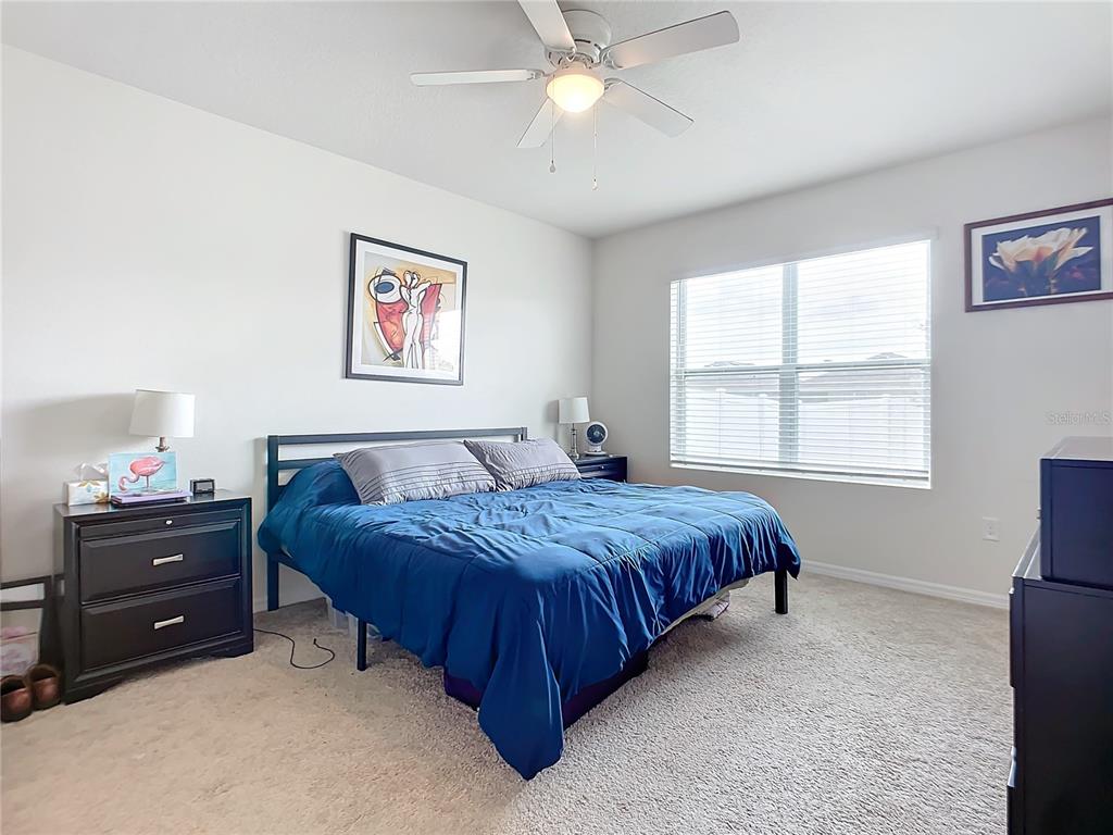 2607 Elmbrooke Way Edgewater, FL 32141 - Photo 40 of 52 a spacious bedroom with a bed and a window