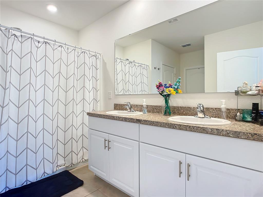 2607 Elmbrooke Way Edgewater, FL 32141 - Photo 41 of 52 a bathroom with a granite countertop sink and a mirror