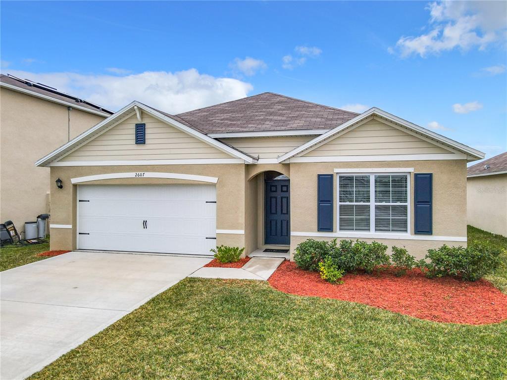 2607 Elmbrooke Way Edgewater, FL 32141 - Photo 52 of 52 a front view of a house with a yard and garage