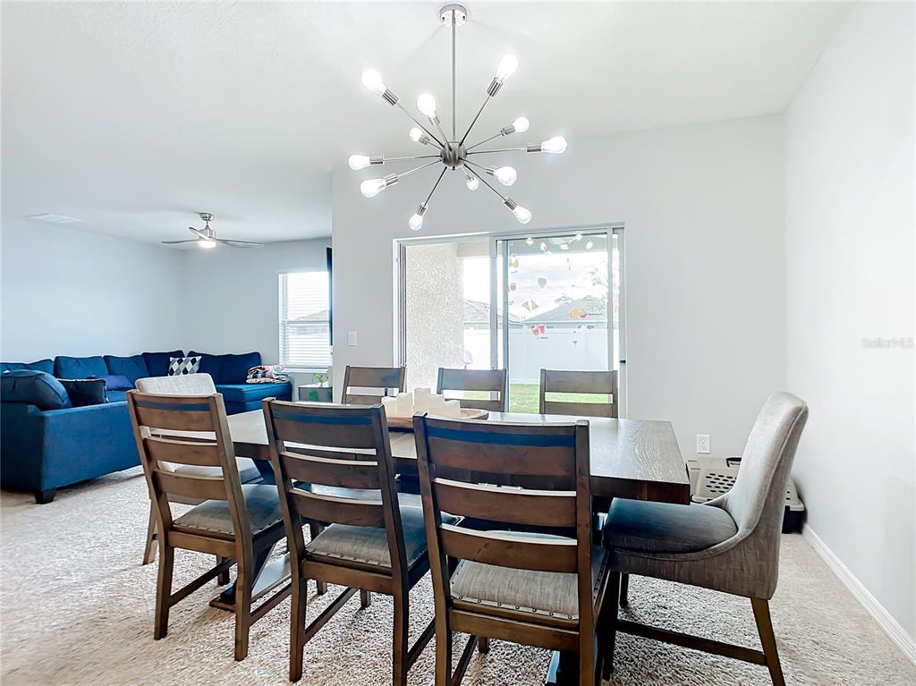 2607 Elmbrooke Way Edgewater, FL 32141 - Photo 8 of 52 a dining room with furniture and window