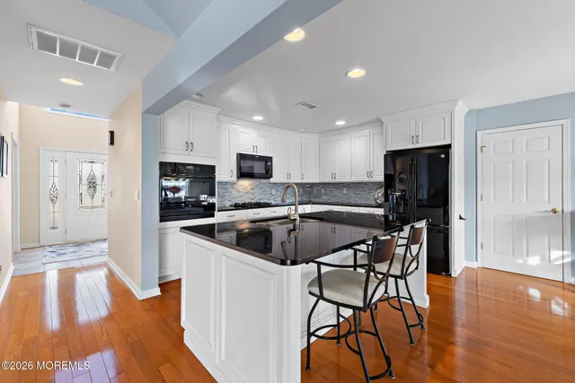 a bedroom with a bed and painting on the wall