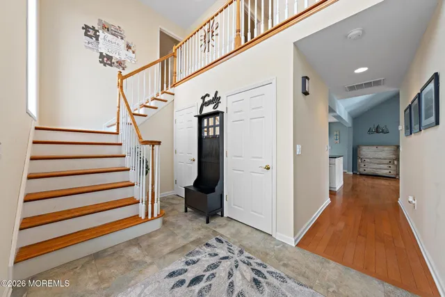 a kitchen with stainless steel appliances granite countertop a stove a sink a microwave a dining table and chairs