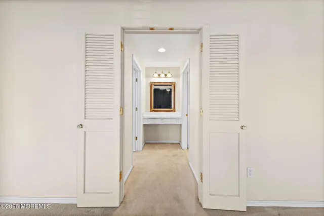 a living room with furniture kitchen view and a large window