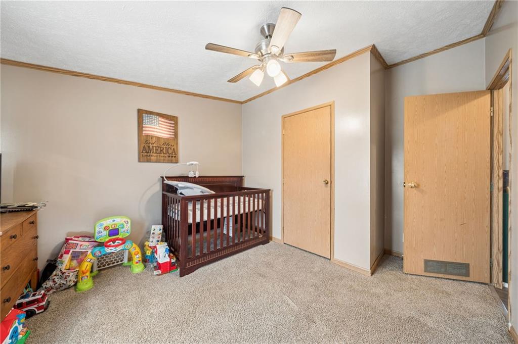 275 Adamik Road Clarksville, PA 15322 - Photo 23 of 39 a bedroom with a bed and a chandelier