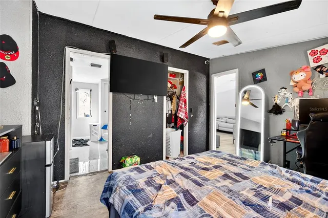 a bedroom with bed and a chandelier