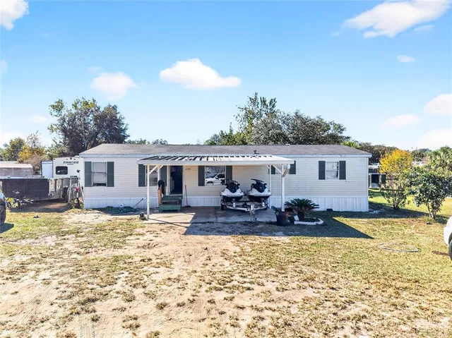 a view of a house with snow in the background