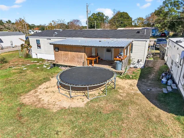 an aerial view of a house with table and chairs