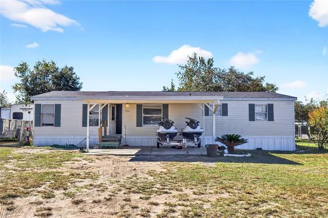 a view of a house with swimming pool and sitting area