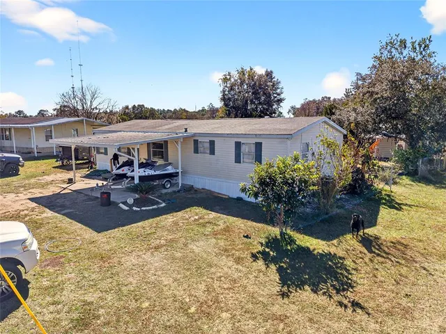 a view of a house with swimming pool and sitting area