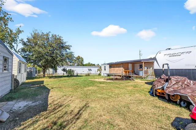 a view of a yard with a car parked in it