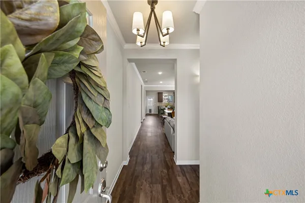 a view of hallway with wooden floor