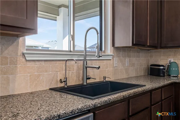 a kitchen with a sink and cabinets