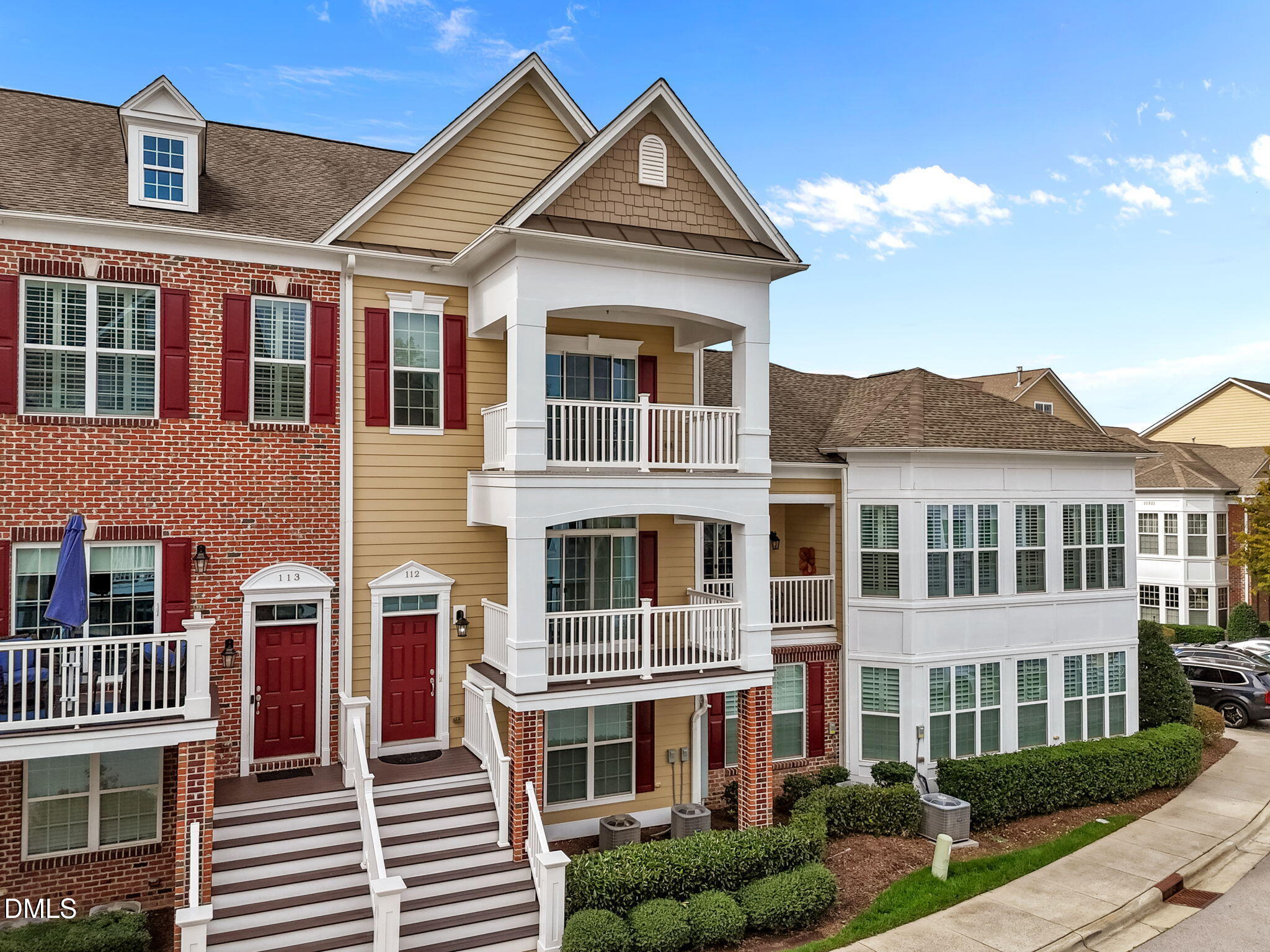 a view of a large white building next to a yard